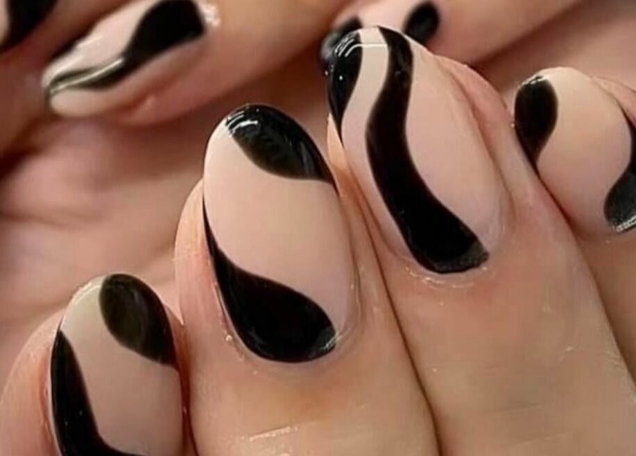 Elegant black swirl nail art at Ells Hair and Nails, Callington, England, GB.