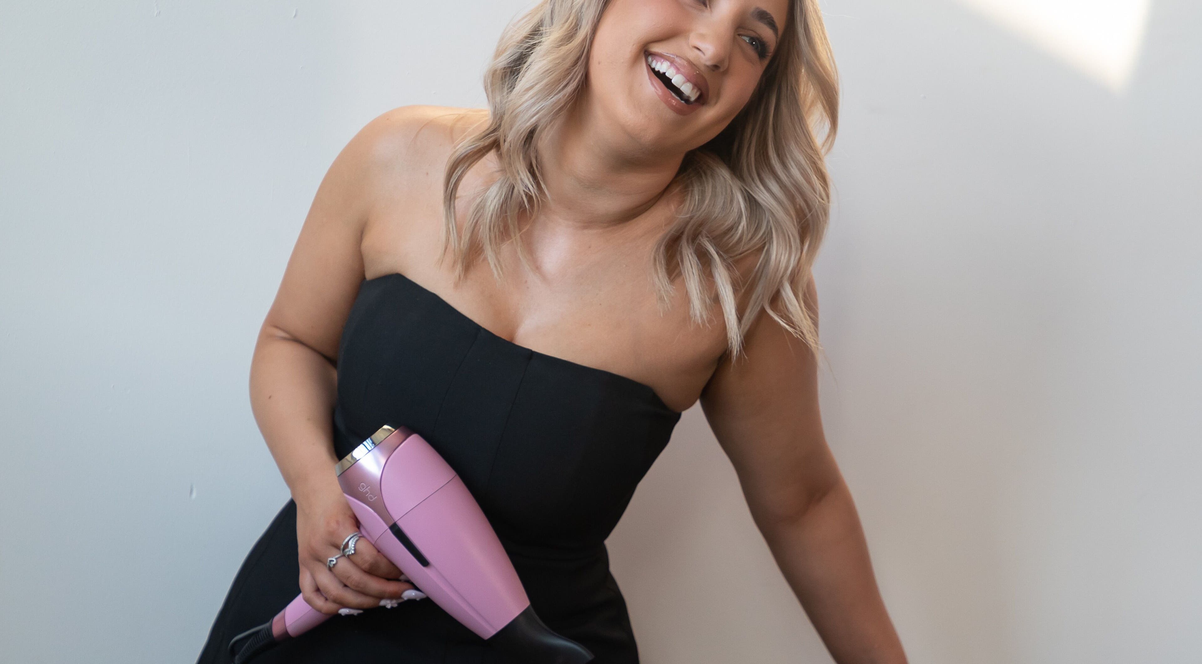 Smiling woman with a hairdryer at StyledByNina, New South Wales, New South Wales, AU.