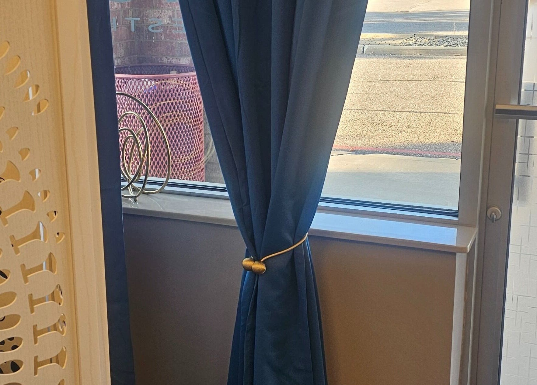 Elegant blue curtain in window at Chizeled Contours Body Aesthetics, Twinsburg, Ohio, US.