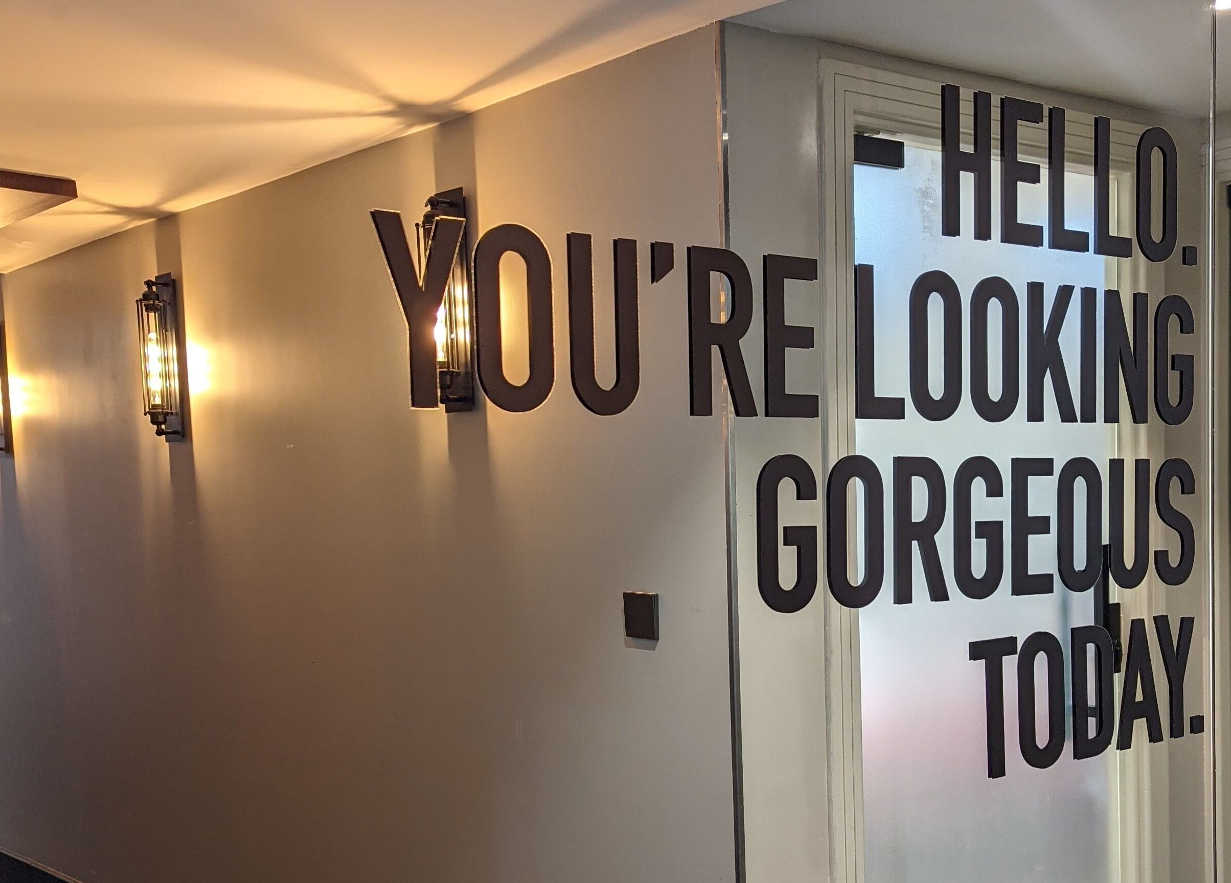 Inspiring wall decor at Supernova Salon Olaya, Riyadh, Riyadh Province, SA with 'You're Looking Gorgeous' text.