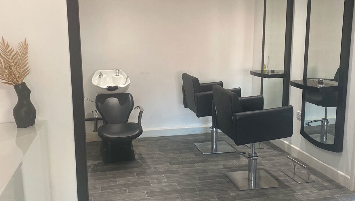 Modern salon interior at More Than Aesthetics in Parkgate, England, GB with stylish chairs and mirrors.