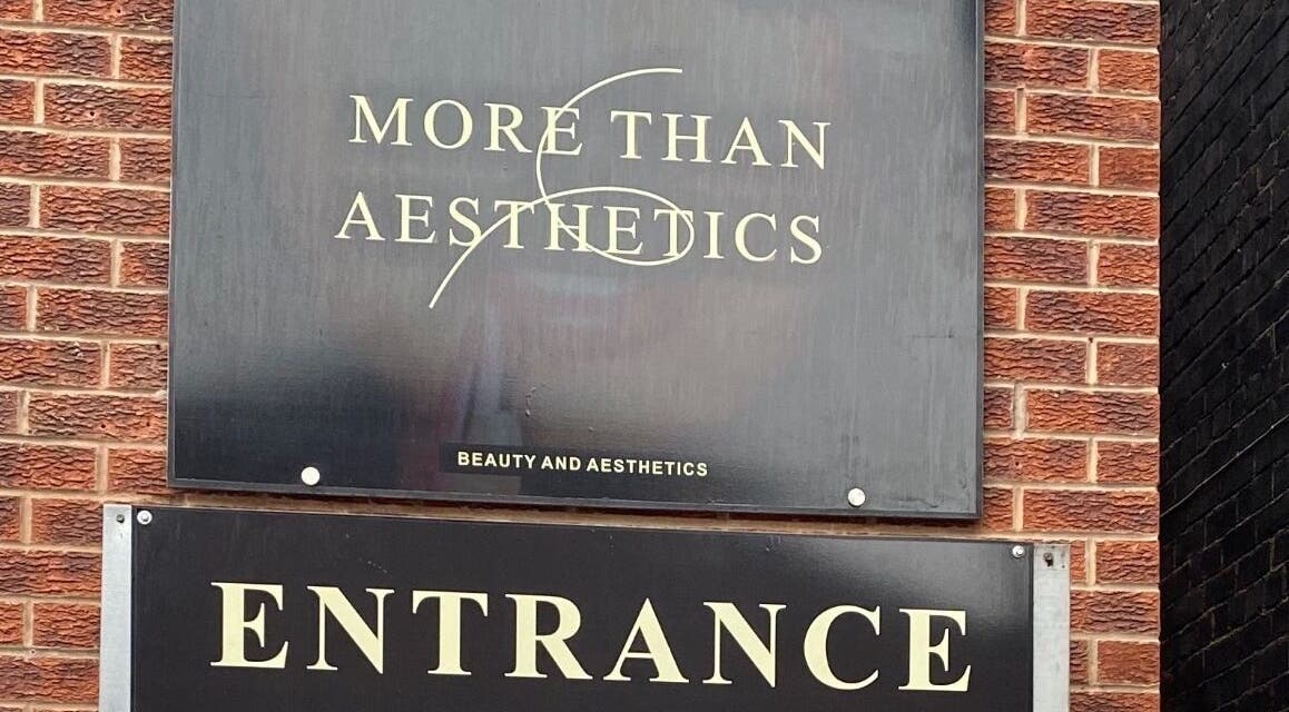 Entrance sign for More Than Aesthetics in Parkgate, England, GB, showcasing their sleek branding.