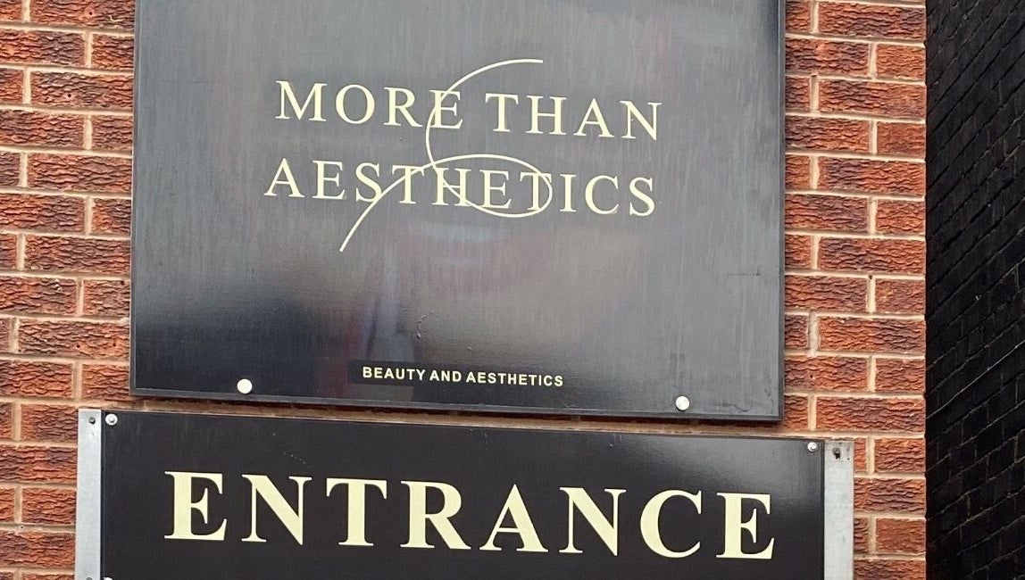 Entrance sign of More Than Aesthetics in Parkgate, England, GB on a stylish brick façade.