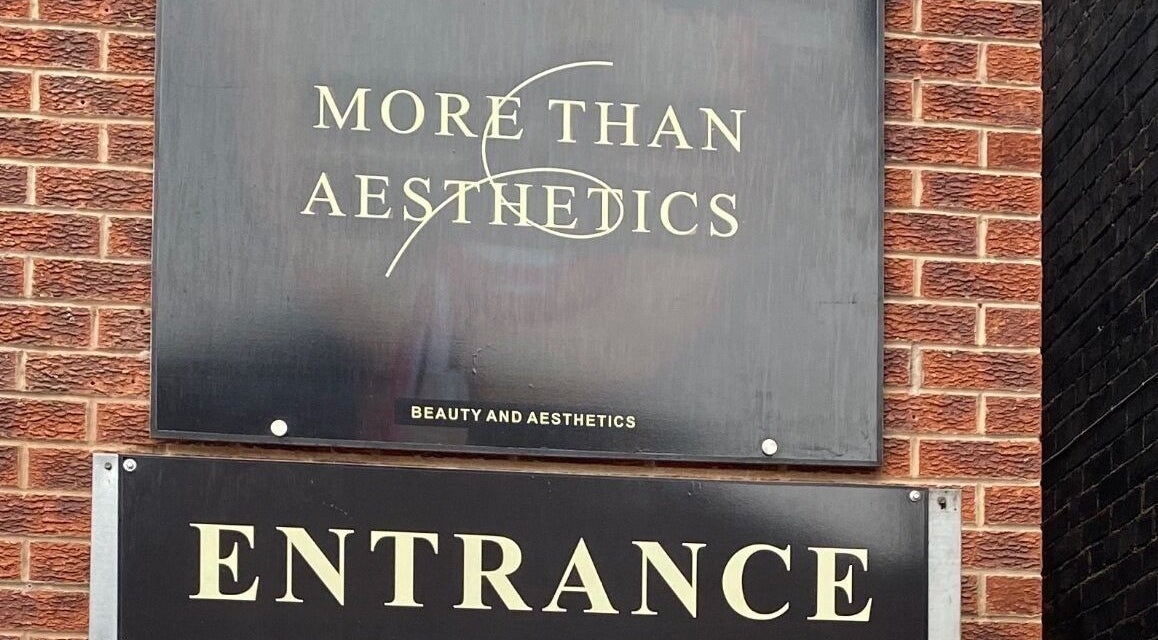 Entrance sign of More Than Aesthetics in Parkgate, England, GB on a stylish brick façade.