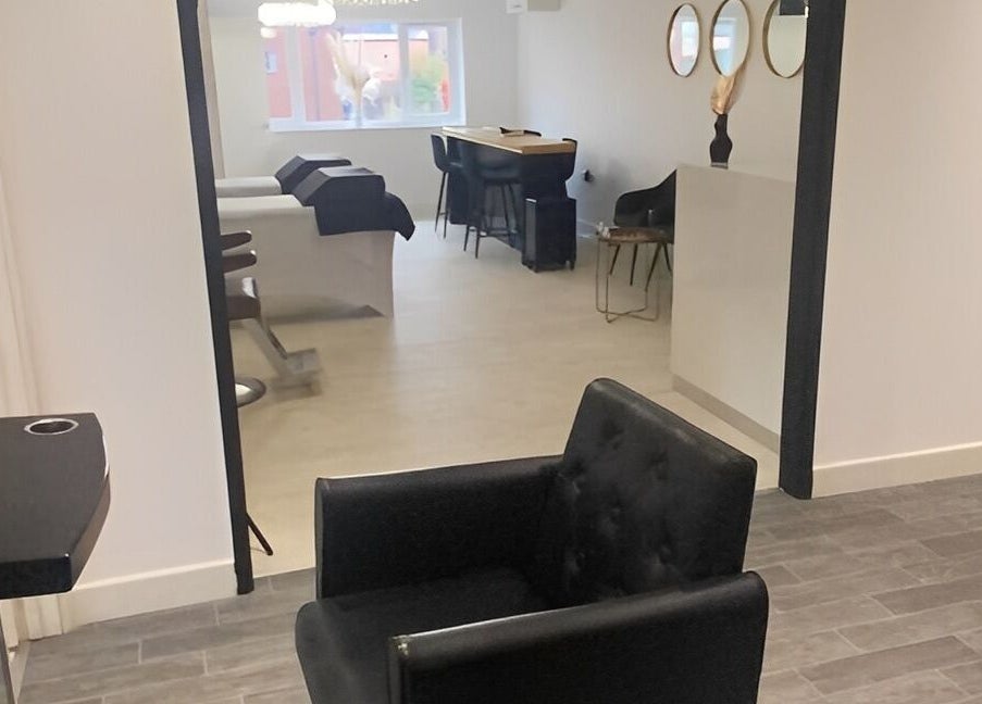 Chic interior of More Than Aesthetics in Parkgate, England, GB showing stylish chairs and treatment tables.