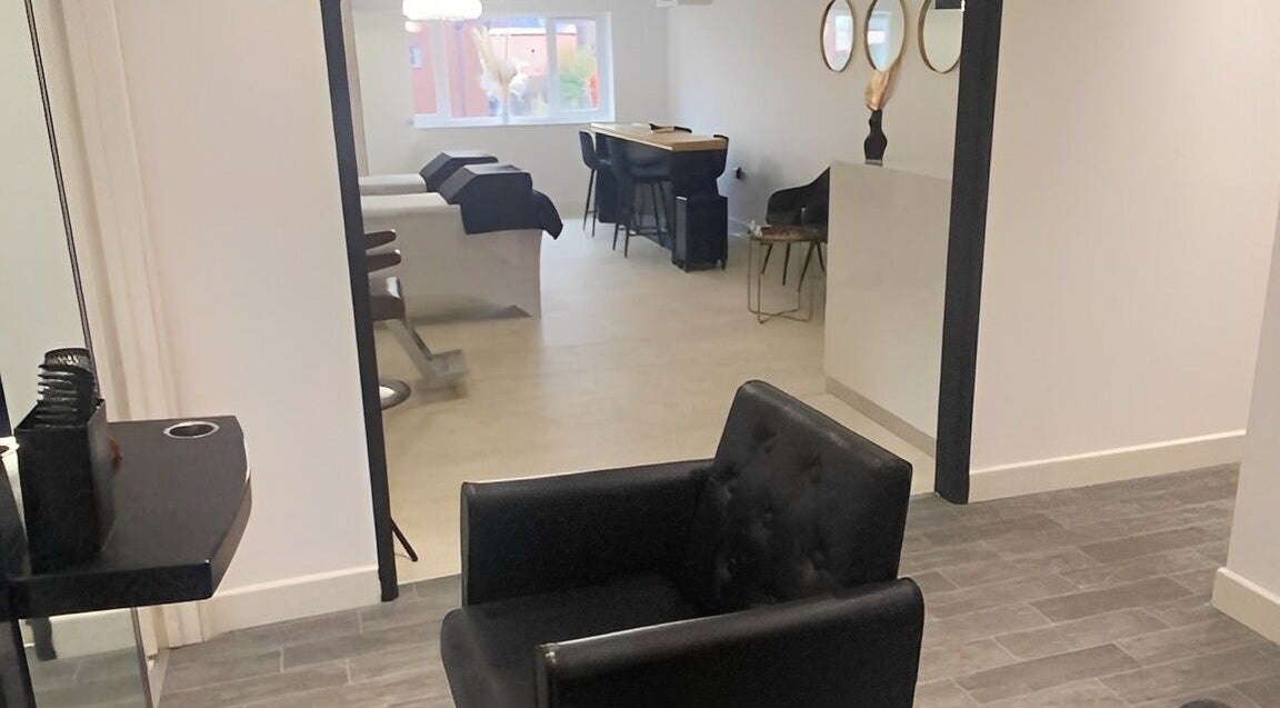 Chic interior of More Than Aesthetics in Parkgate, England, GB showing stylish chairs and treatment tables.