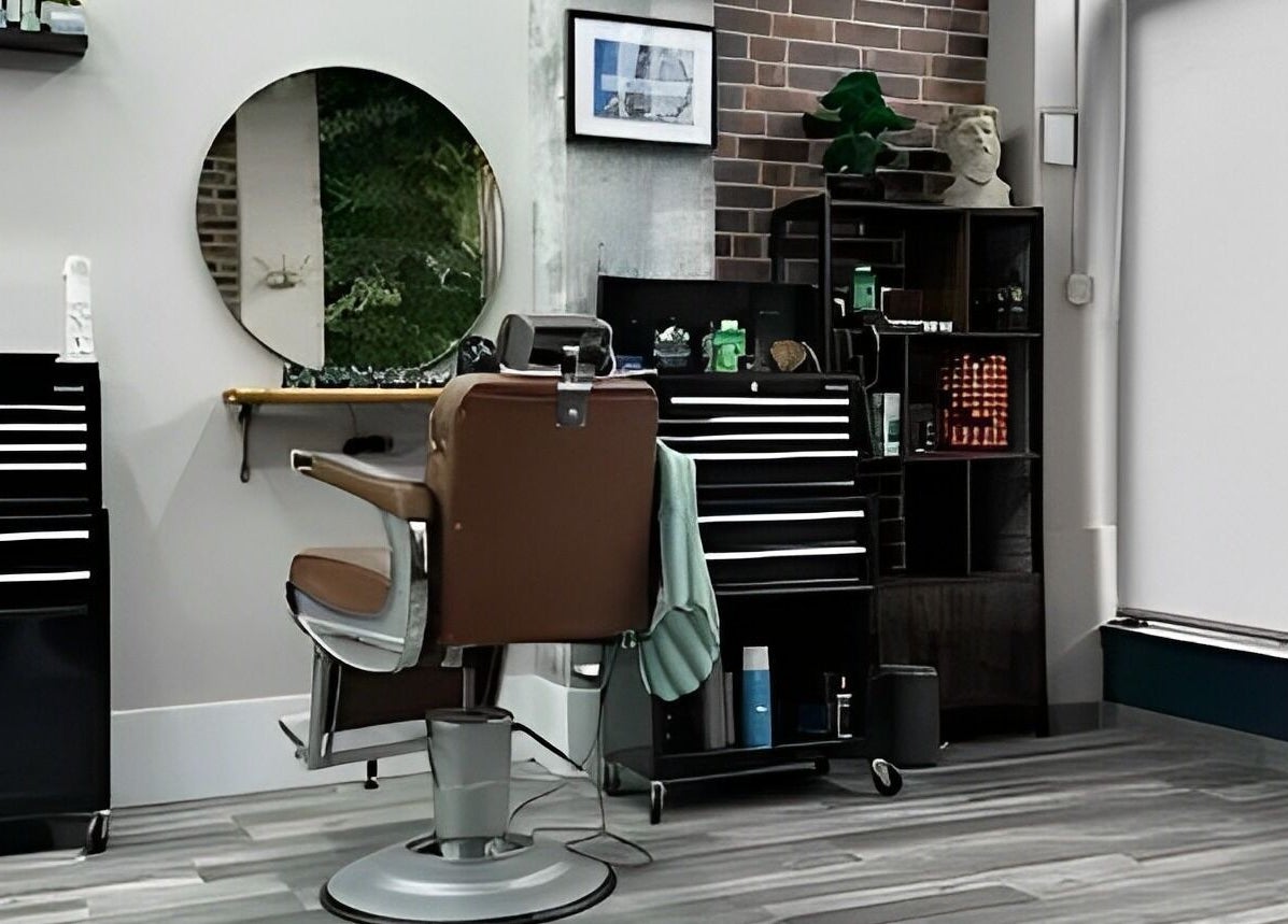 Modern barber chair at The Man Cave Barbershop in Northampton, England, GB, showcasing sleek interior design.