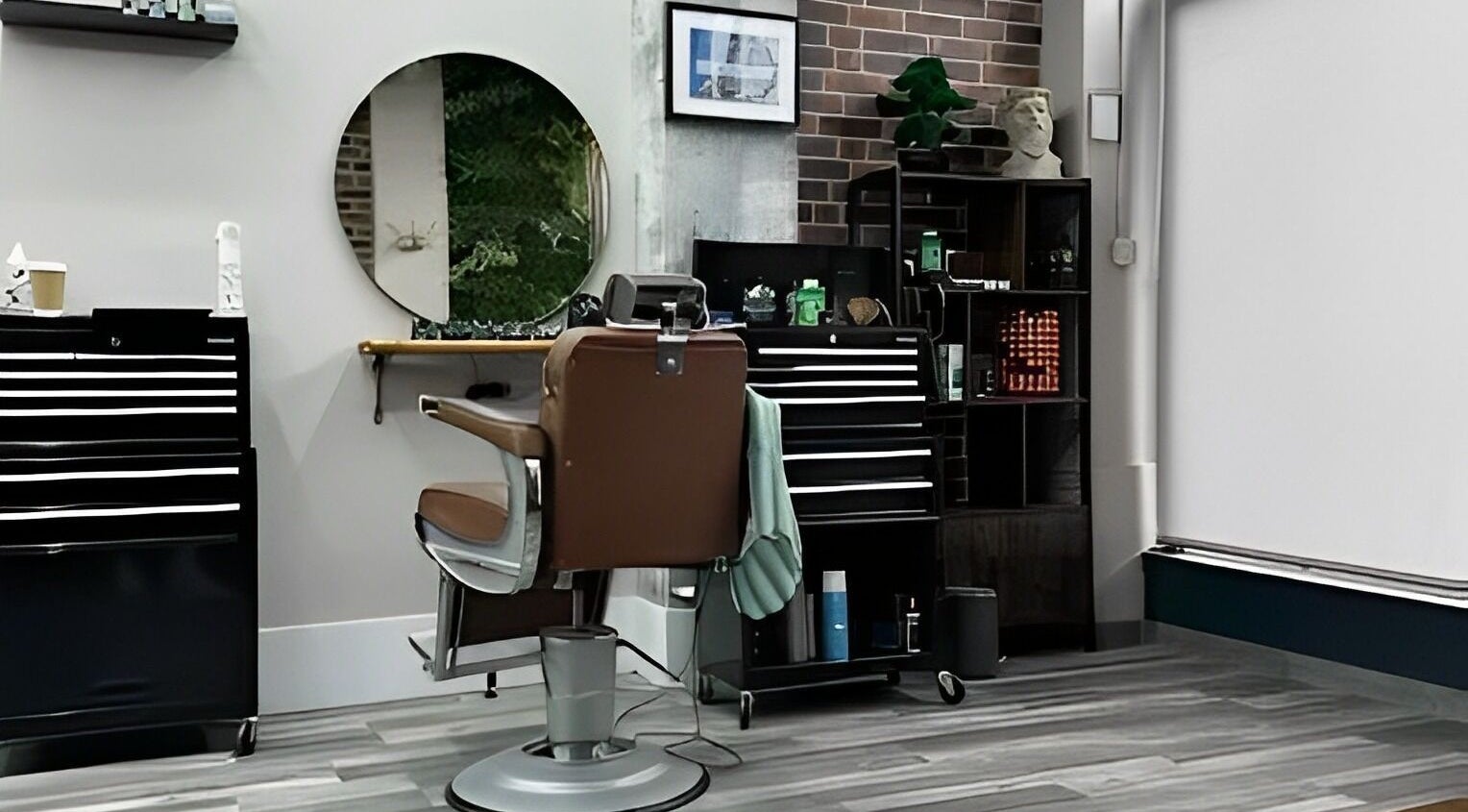 Modern barber chair at The Man Cave Barbershop in Northampton, England, GB, showcasing sleek interior design.