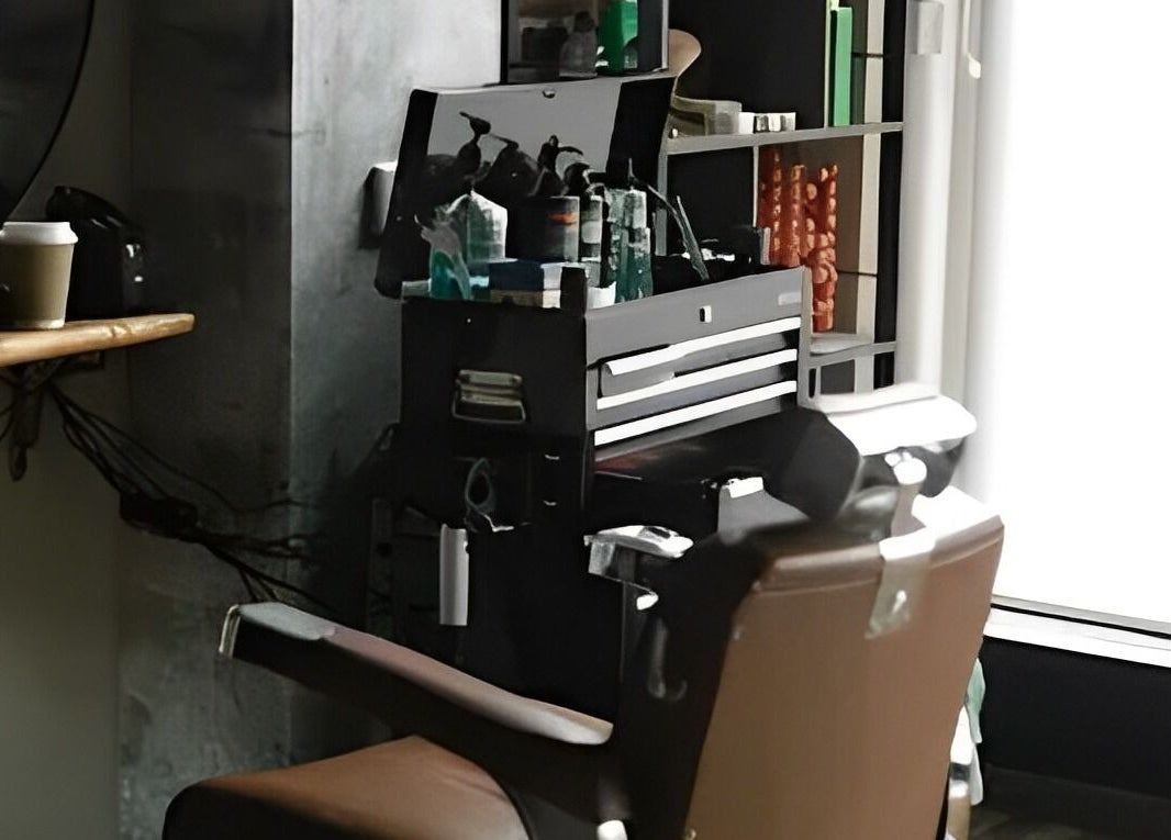 The Man Cave Barbershop interior with a brown chair and styling tools in Northampton, England, GB.