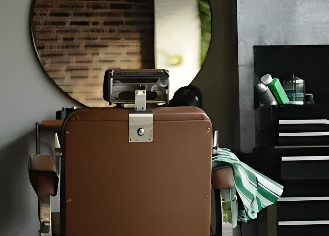 Classic barber chair at The Man Cave Barbershop, Northampton, England, GB with tools and mirror.