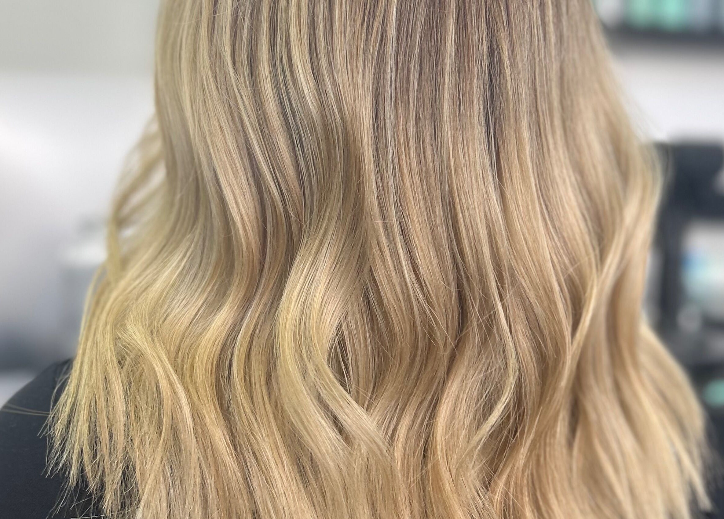 Flowing golden blonde waves at Blond by Jade in Willaston, South Australia, AU showcasing hair styling.