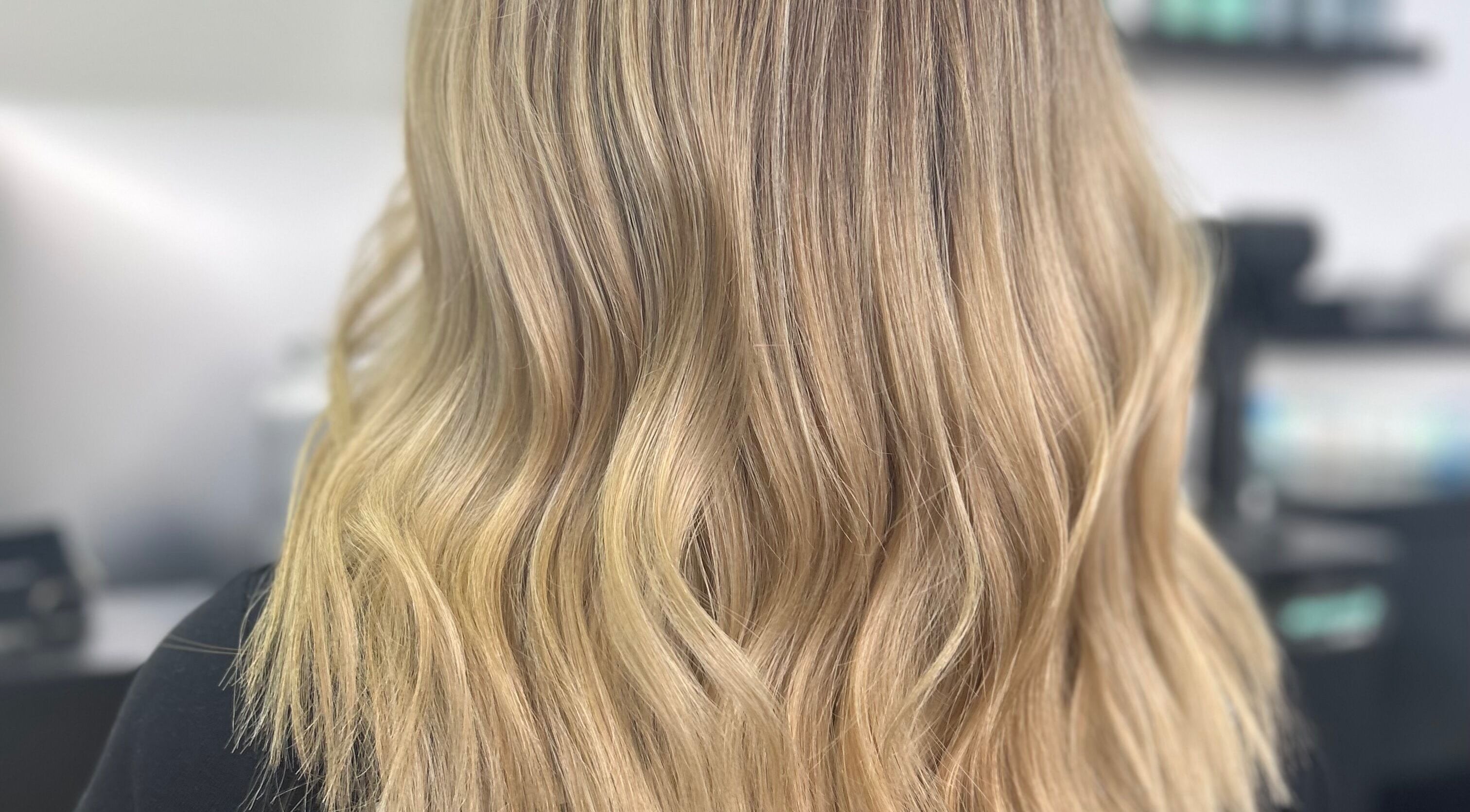 Flowing golden blonde waves at Blond by Jade in Willaston, South Australia, AU showcasing hair styling.
