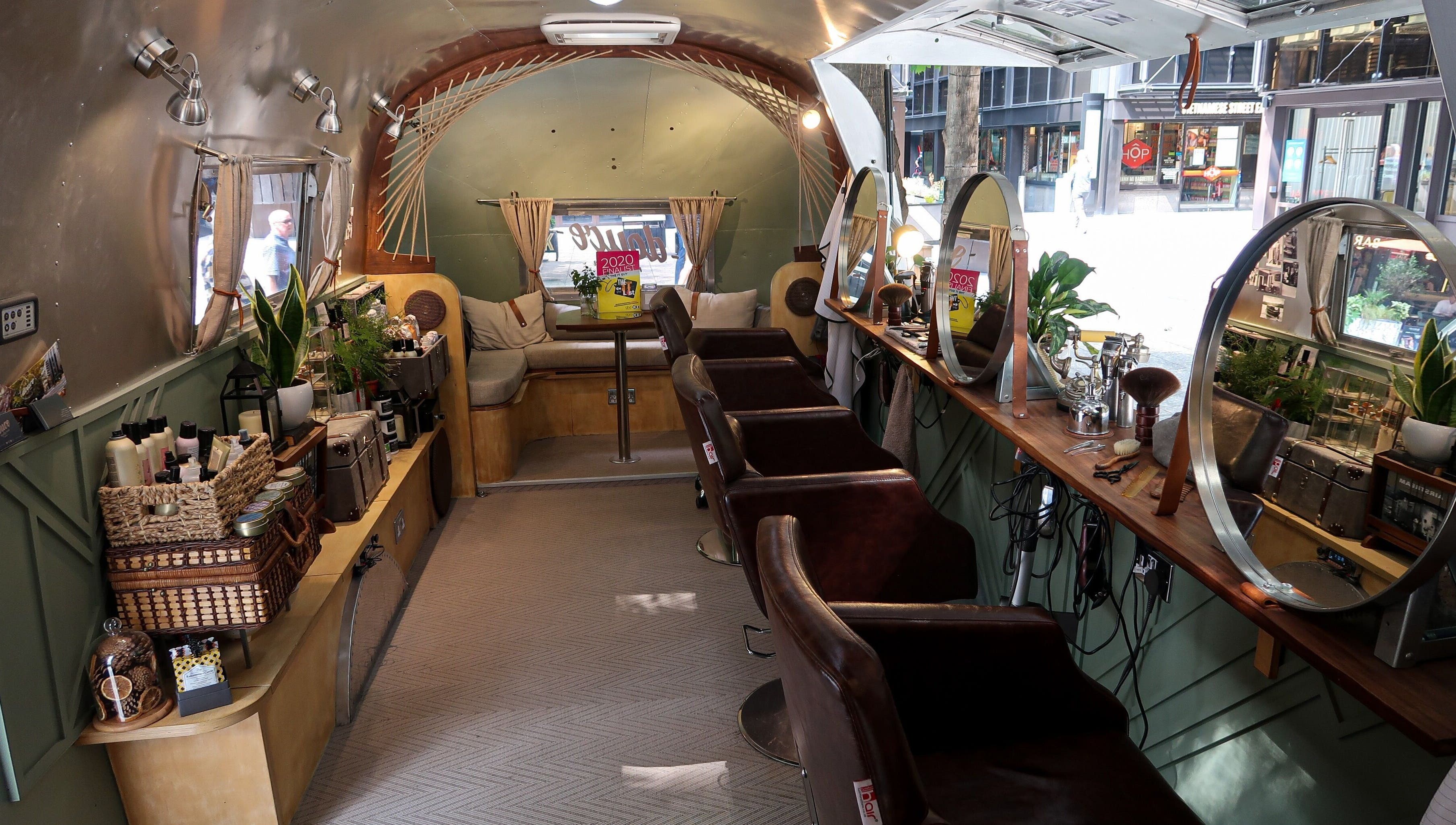 Interior of Douce Shoreditch mobile salon in an Airstream, featuring mirrors and styling chairs in London, England, GB.