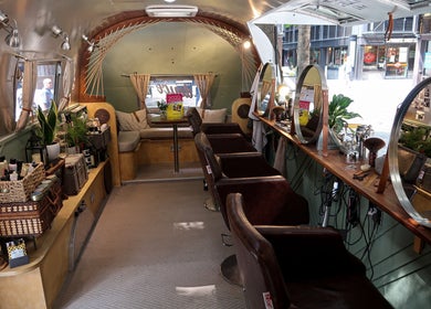 Interior of Douce Shoreditch mobile salon in an Airstream, featuring mirrors and styling chairs in London, England, GB.