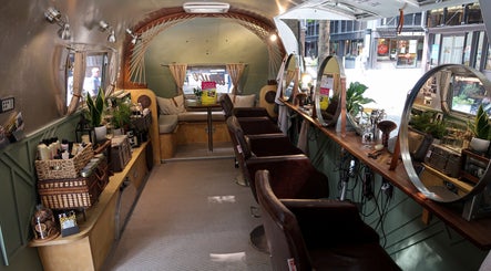 Interior of Douce Shoreditch mobile salon in an Airstream, featuring mirrors and styling chairs in London, England, GB.