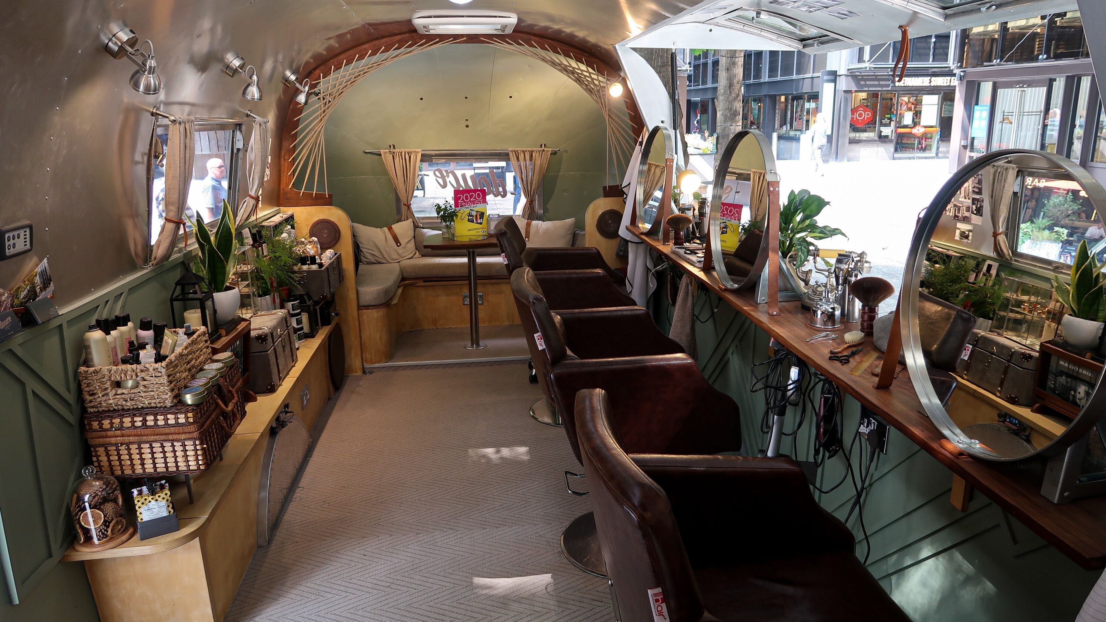 Interior of Douce Shoreditch mobile salon in an Airstream, featuring mirrors and styling chairs in London, England, GB.