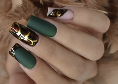 Detailed nail art at Avc beauty(Castle Aesthetics), Colchester, England, GB, showcasing green and gold designs.