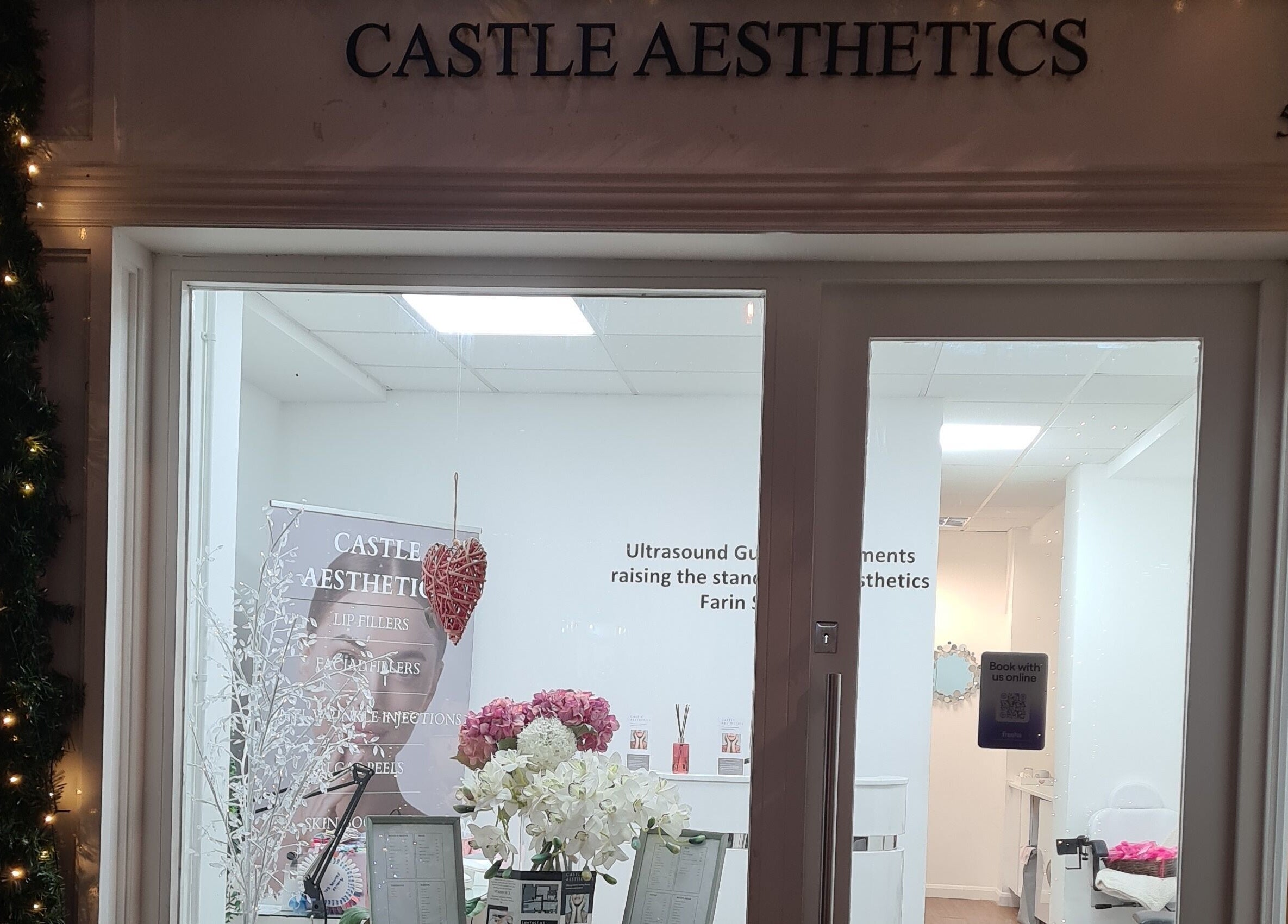Charming entrance of Avc beauty Castle Aesthetics in Colchester, England, GB, adorned with festive lights.