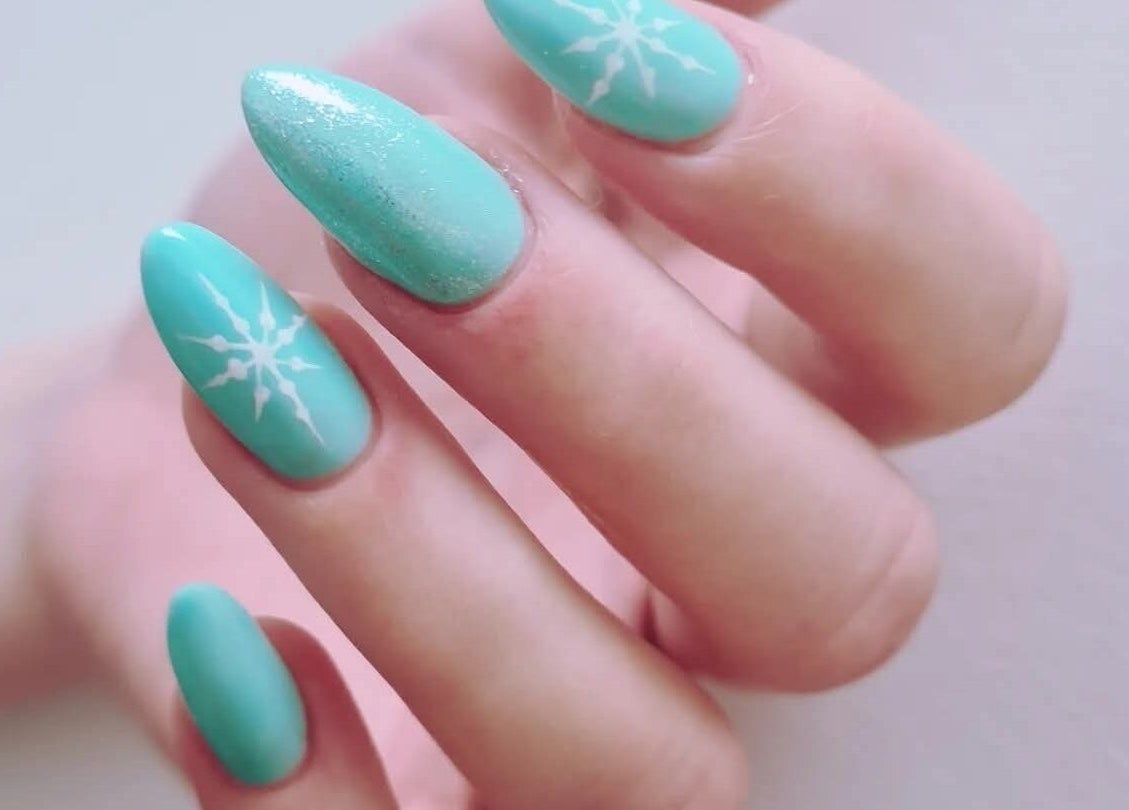 Aqua blue nails with snowflake art, showcasing Avc beauty Castle Aesthetics' talent in Colchester, England, GB.