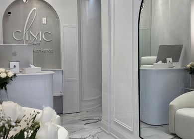 Chic reception area of Aesthetic Nurse Marta in Vaughan, Ontario, CA, featuring white decor and floral accents.