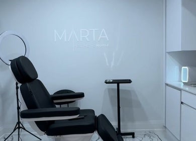 Modern treatment room at Aesthetic Nurse Marta in Vaughan, Ontario, CA with sleek chair and minimalist decor.