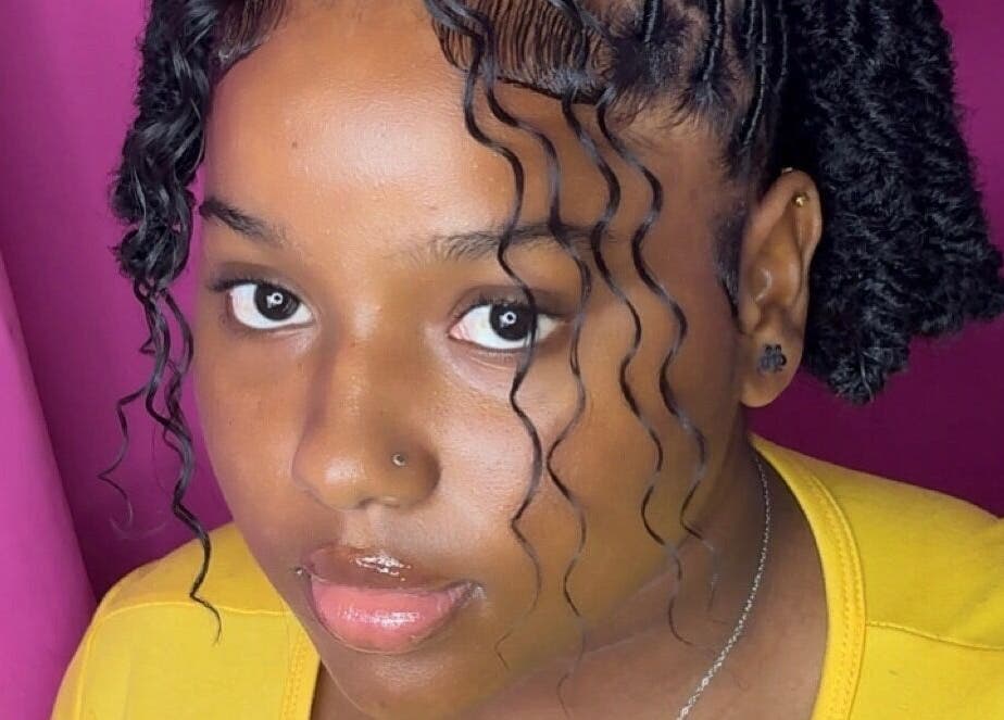 A stylish woman with curly hair at Bella Vida 246, Union Hall, Saint Philip, BB.