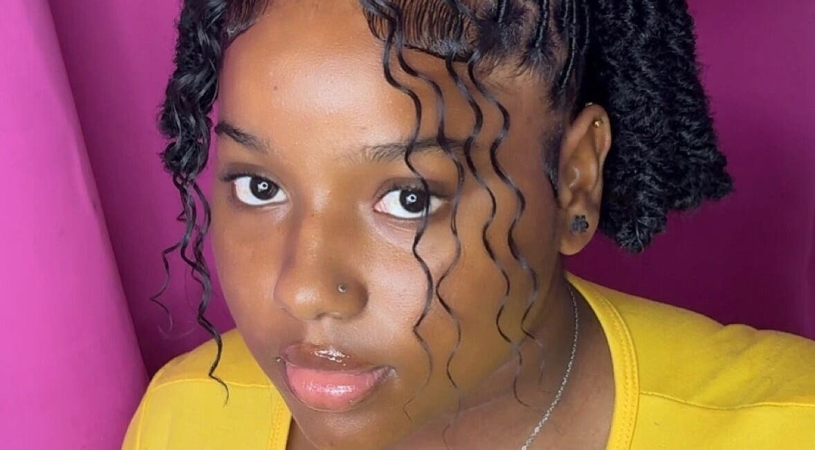 A stylish woman with curly hair at Bella Vida 246, Union Hall, Saint Philip, BB.