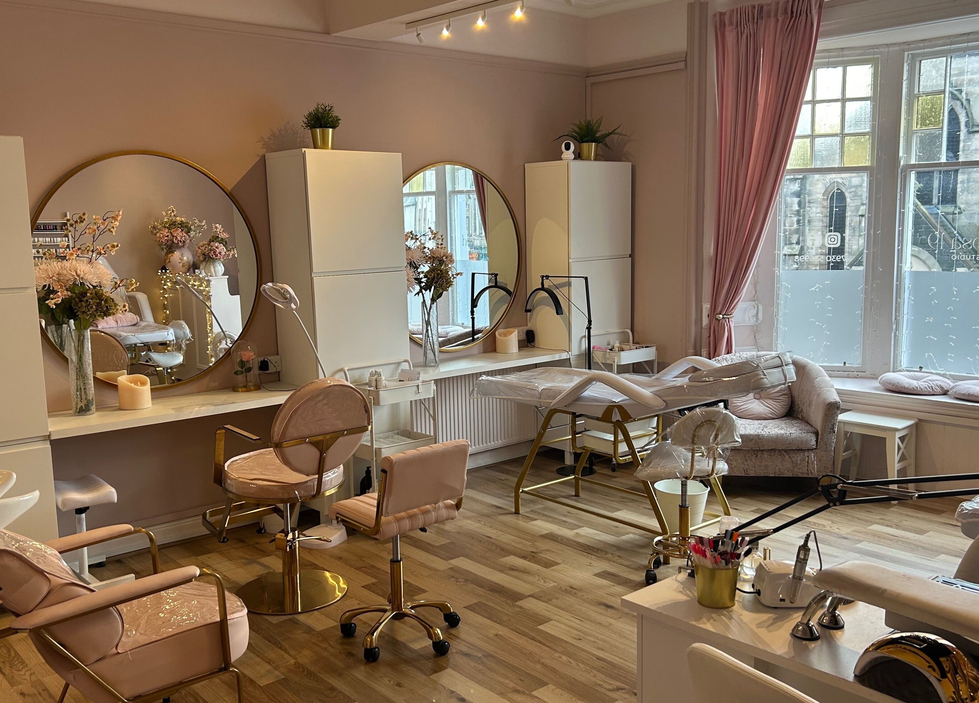 Chic interior of Hermosa19 Beauty in Peebles, Scotland, GB showcasing plush seating and large mirrors.