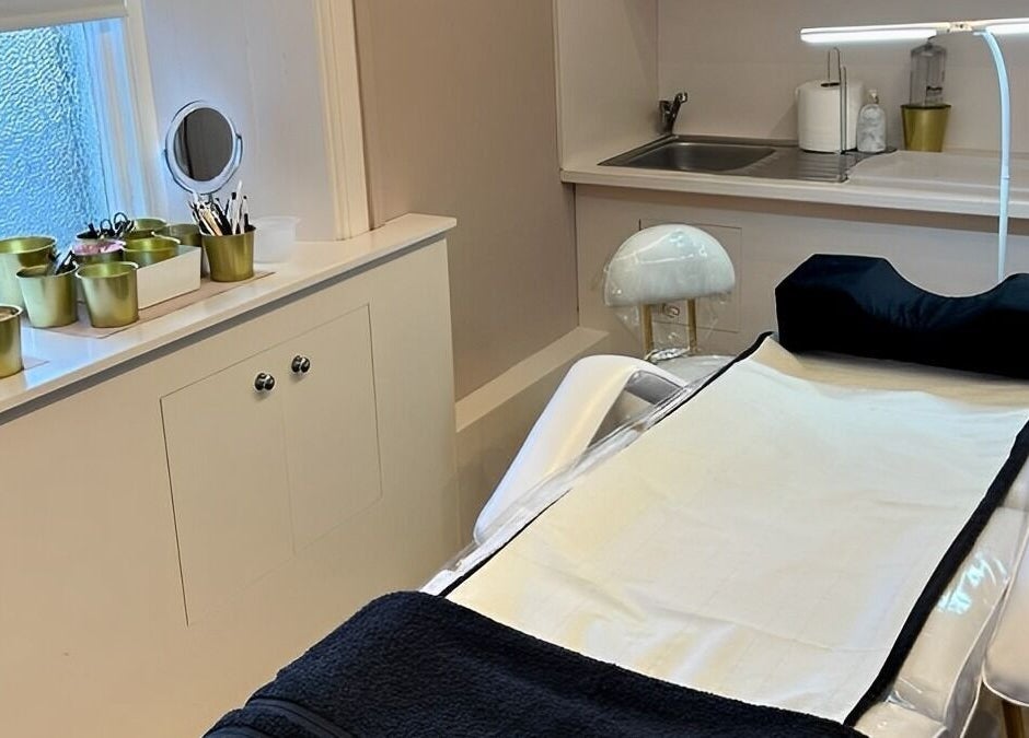 Calm treatment room at Hermosa19 Beauty, Peebles, Scotland, GB with white and gold decor.