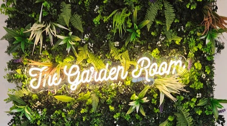 Greenery and neon 'The Garden Room' sign at The Garden Room, Havant, England, GB.
