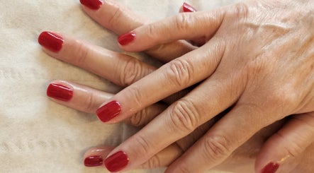 Elegant red manicured nails at The Garden Room, Havant, England, GB offering luxurious beauty treatments.