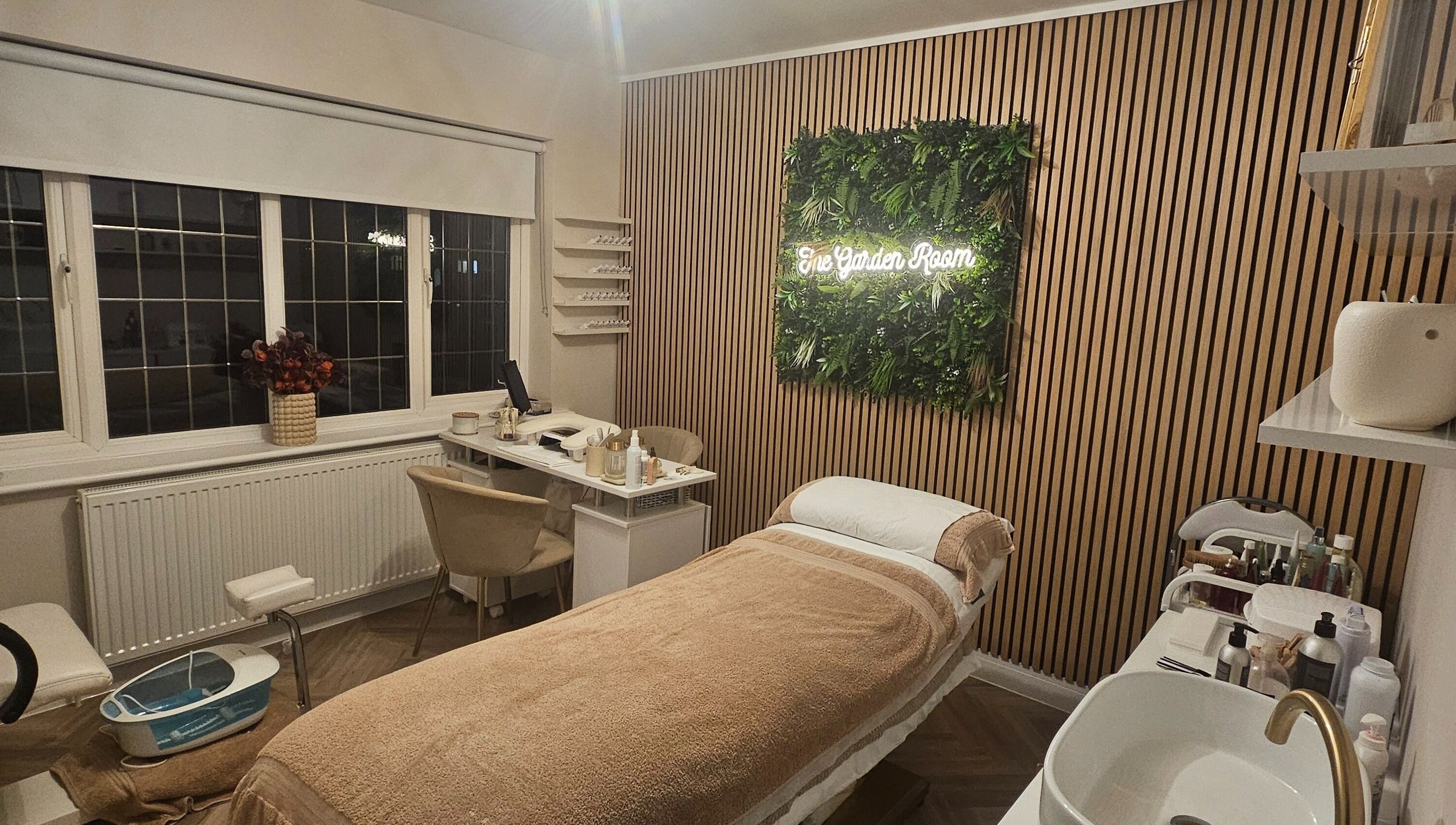Relaxing treatment room at The Garden Room, Havant, England, GB with elegant decor and a treatment bed.