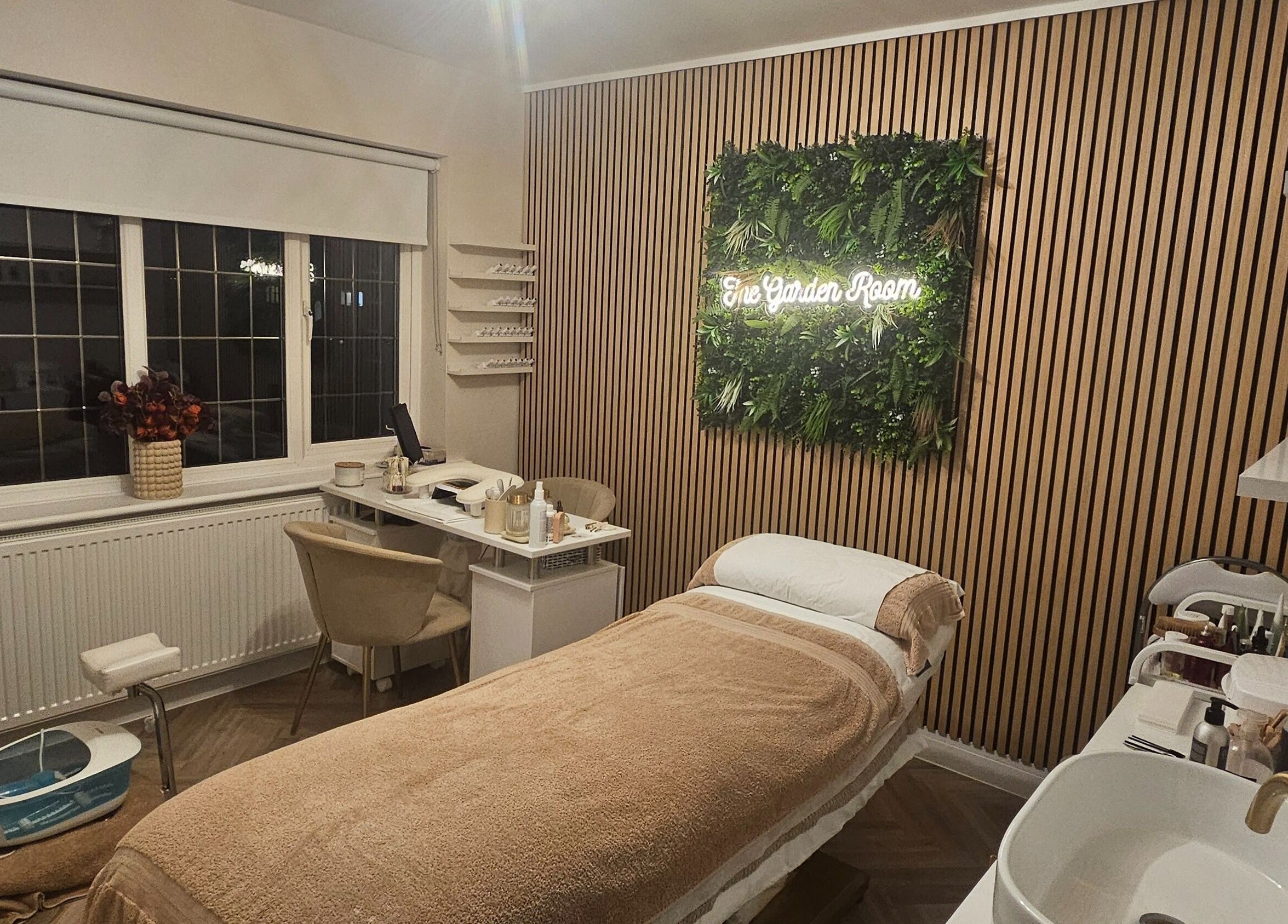 Relaxing treatment room at The Garden Room, Havant, England, GB with elegant decor and a treatment bed.