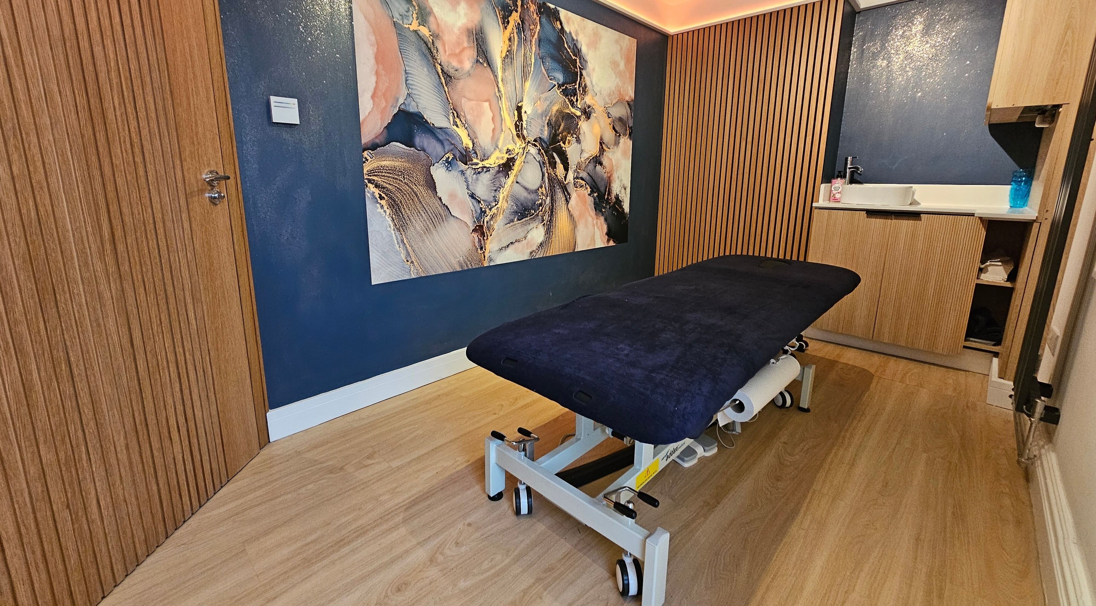 Stylish therapy room at Equilize Holistic Therapies, Wadhurst, England, GB with elegant decor and massage table.