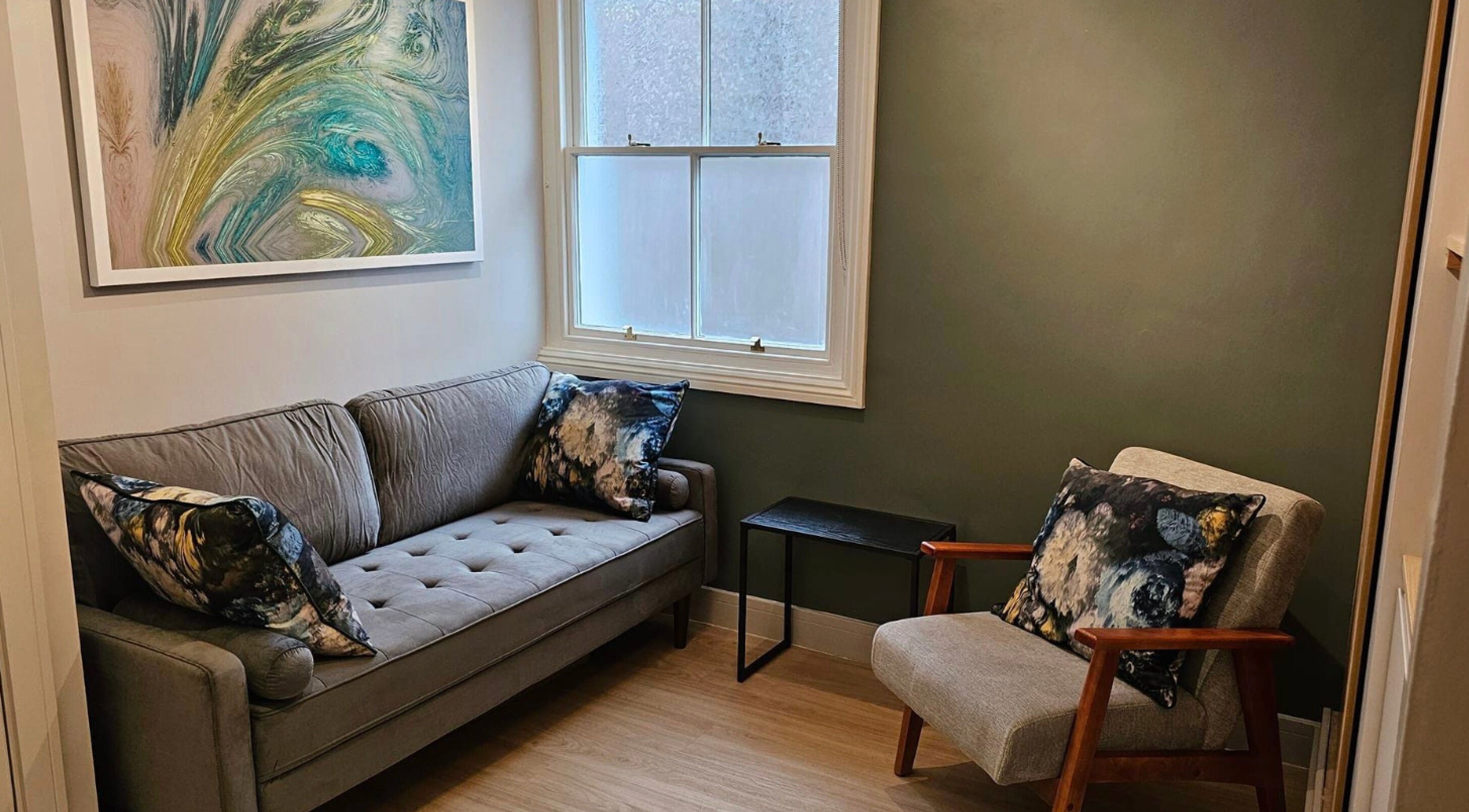 Cozy seating area with abstract art at Equilize Holistic Therapies, Wadhurst, England, GB.