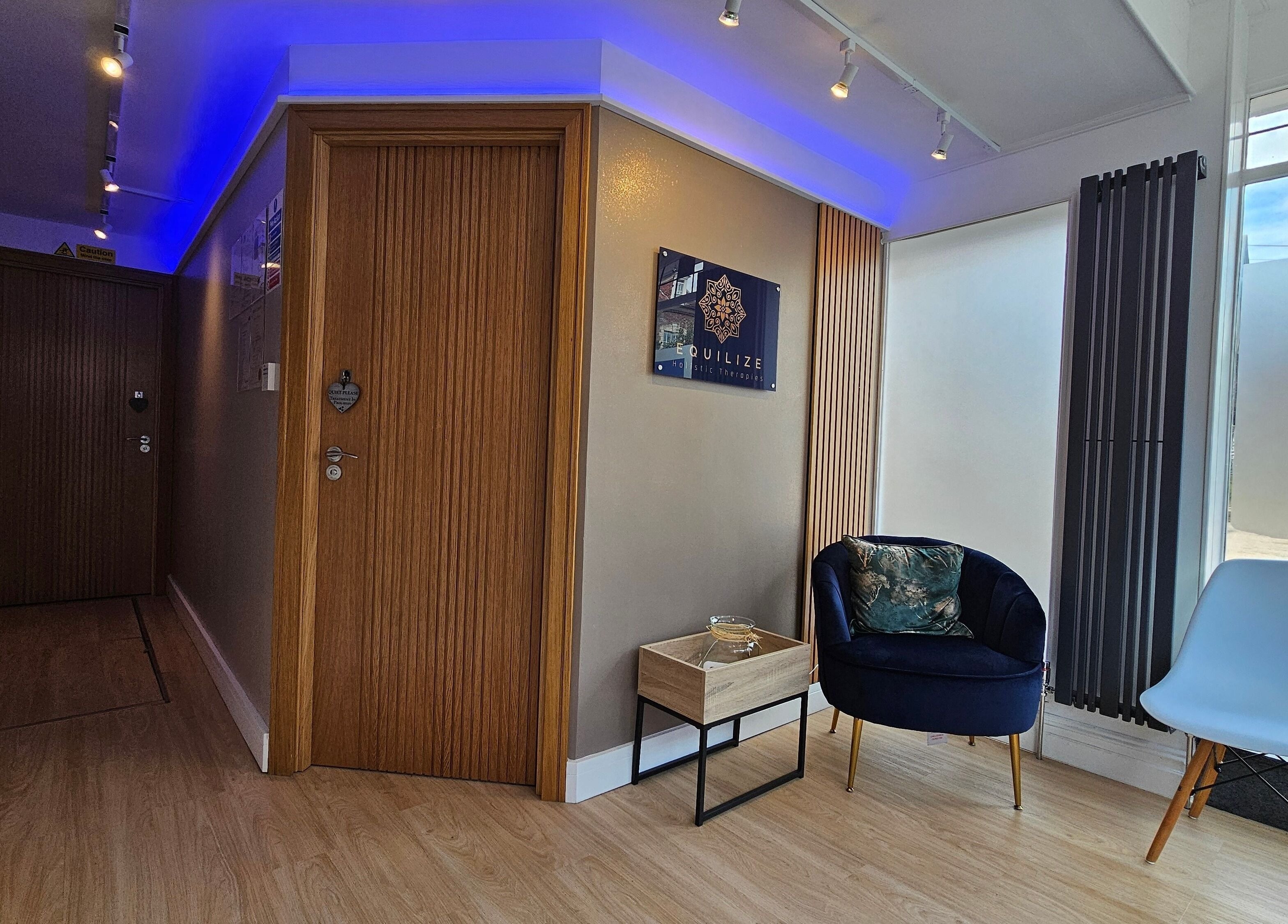 Tranquil reception area at Equilize Holistic Therapies in Wadhurst, England featuring modern chairs and decor.