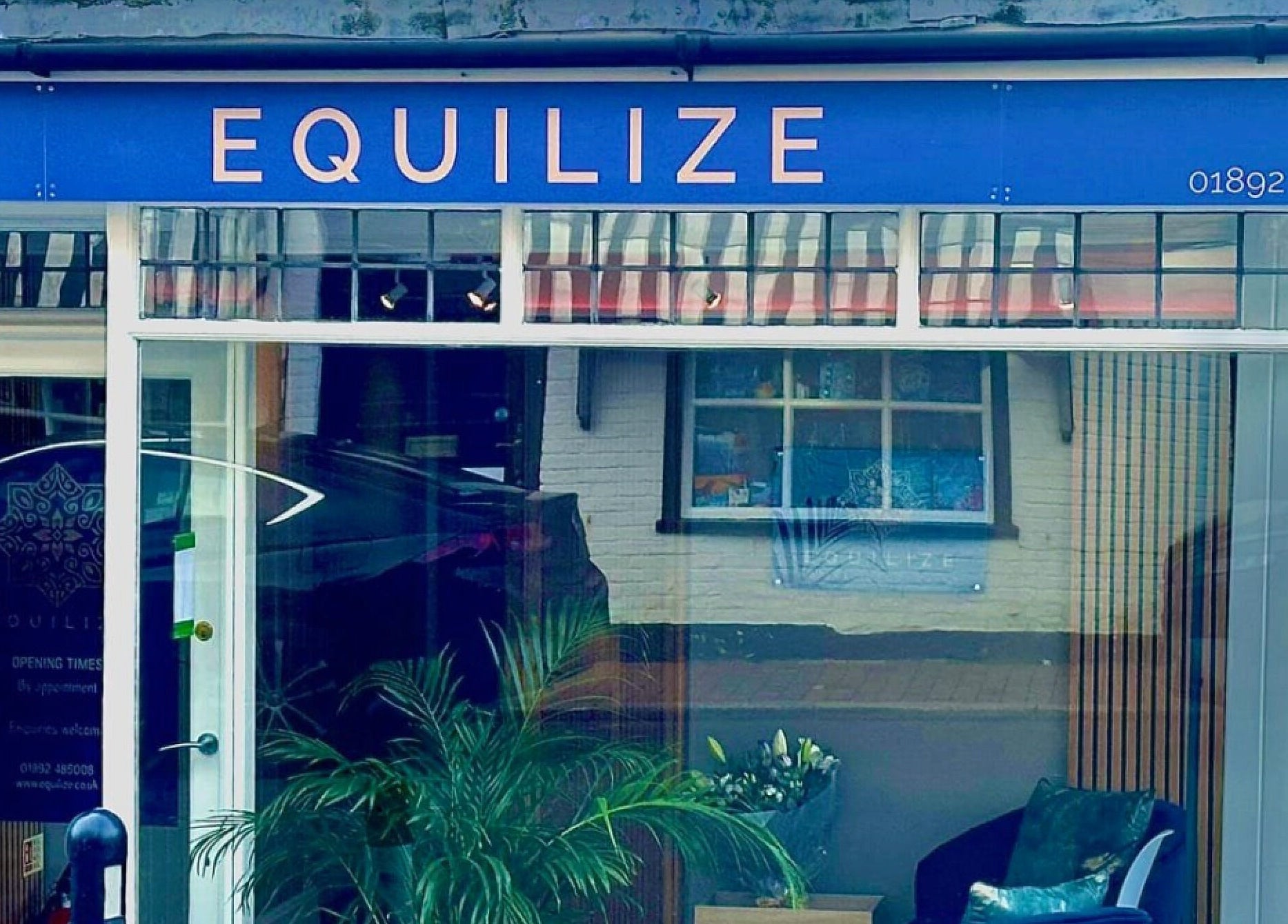 Front view of Equilize Holistic Therapies in Wadhurst, England, GB showcasing a vibrant blue sign.