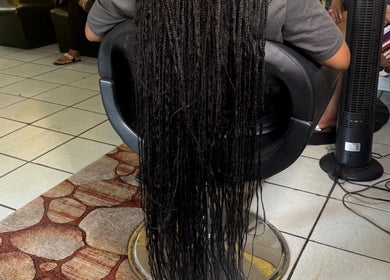 Intricate braids at Goldy Mane Collection, Miami, Florida, US, showcasing expert hair styling.