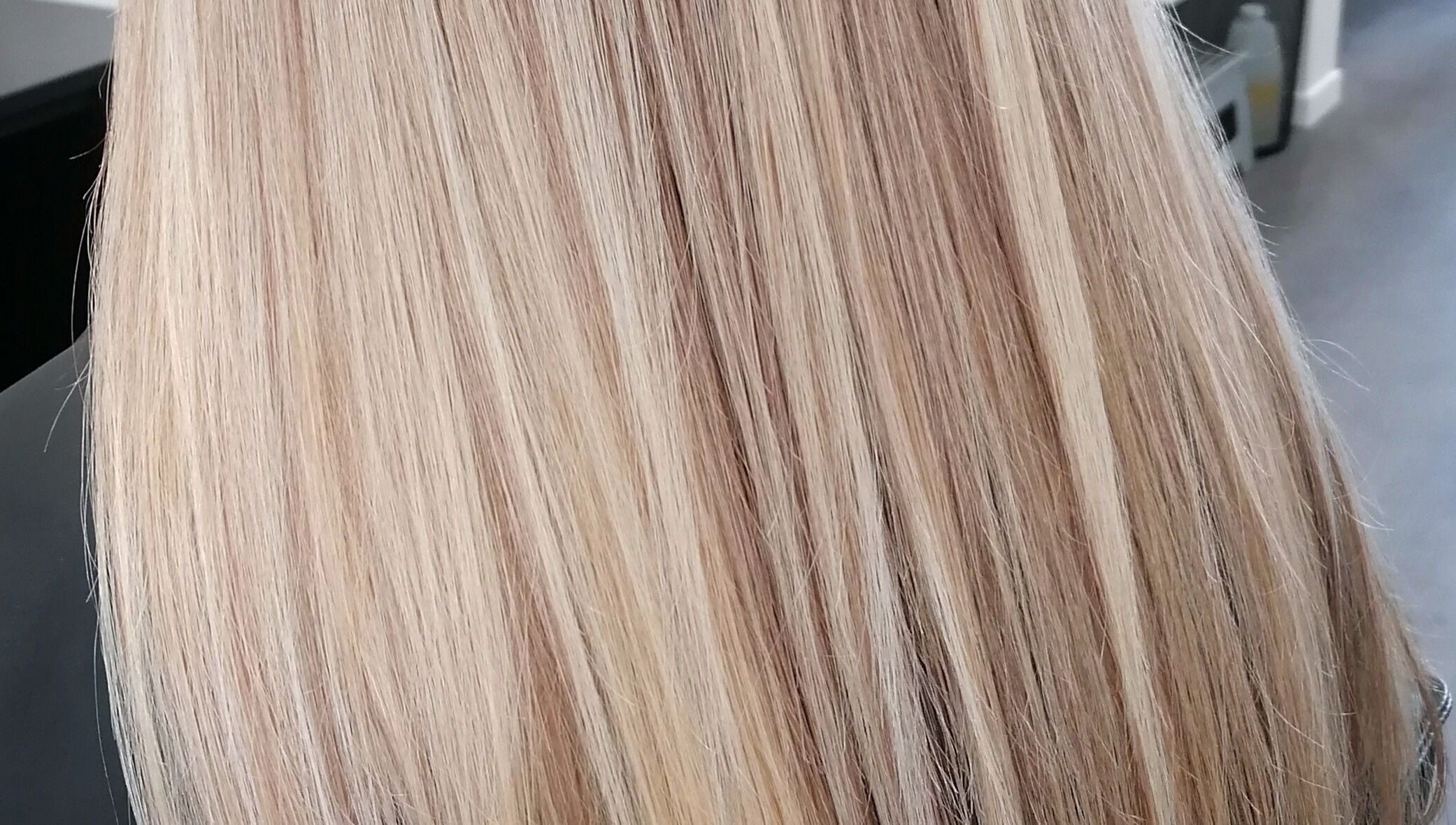 Blonde hair styled at Hair by Nicola Smit, Pretoria, Gauteng, ZA, showcasing silky shine and smooth finish.