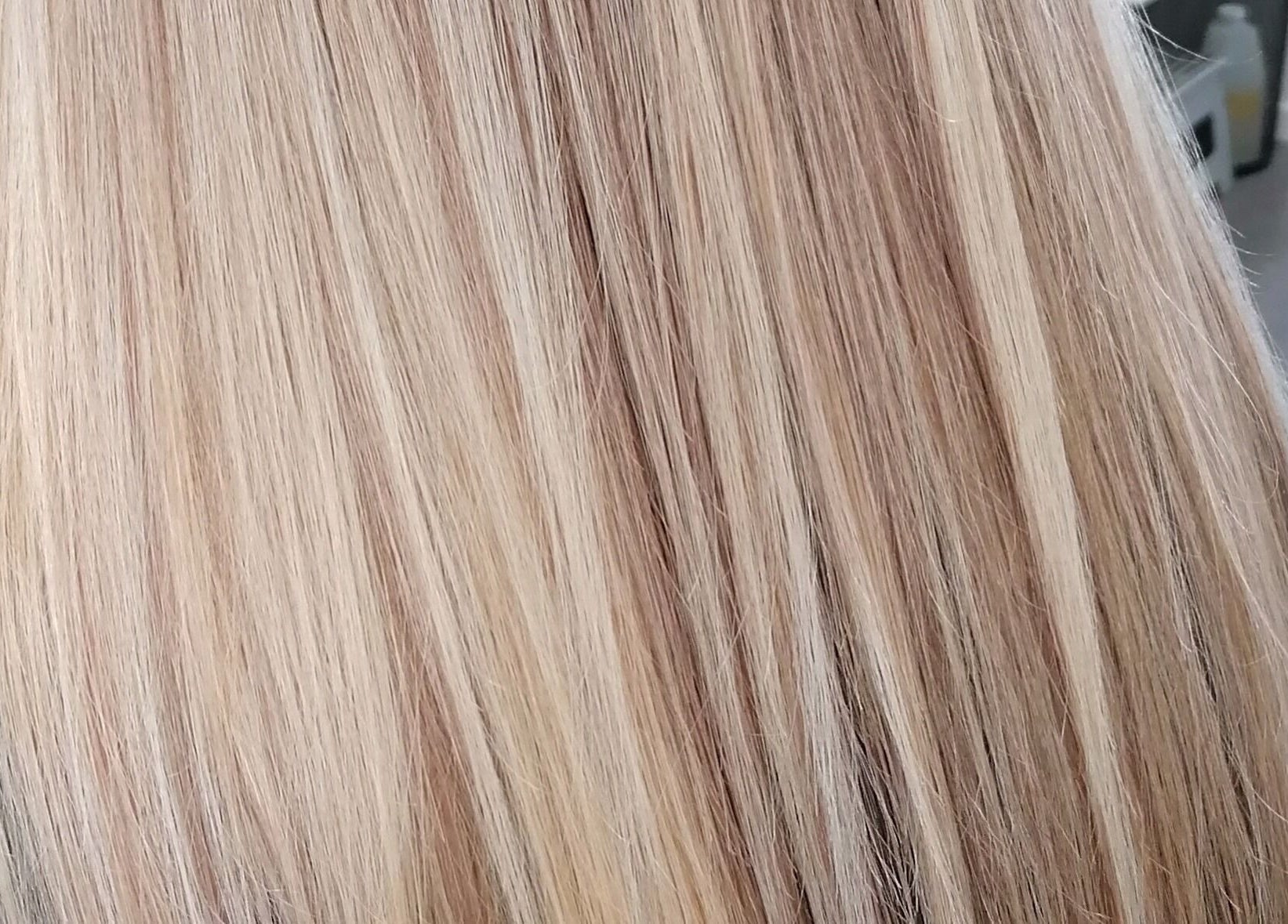 Blonde hair styled at Hair by Nicola Smit, Pretoria, Gauteng, ZA, showcasing silky shine and smooth finish.