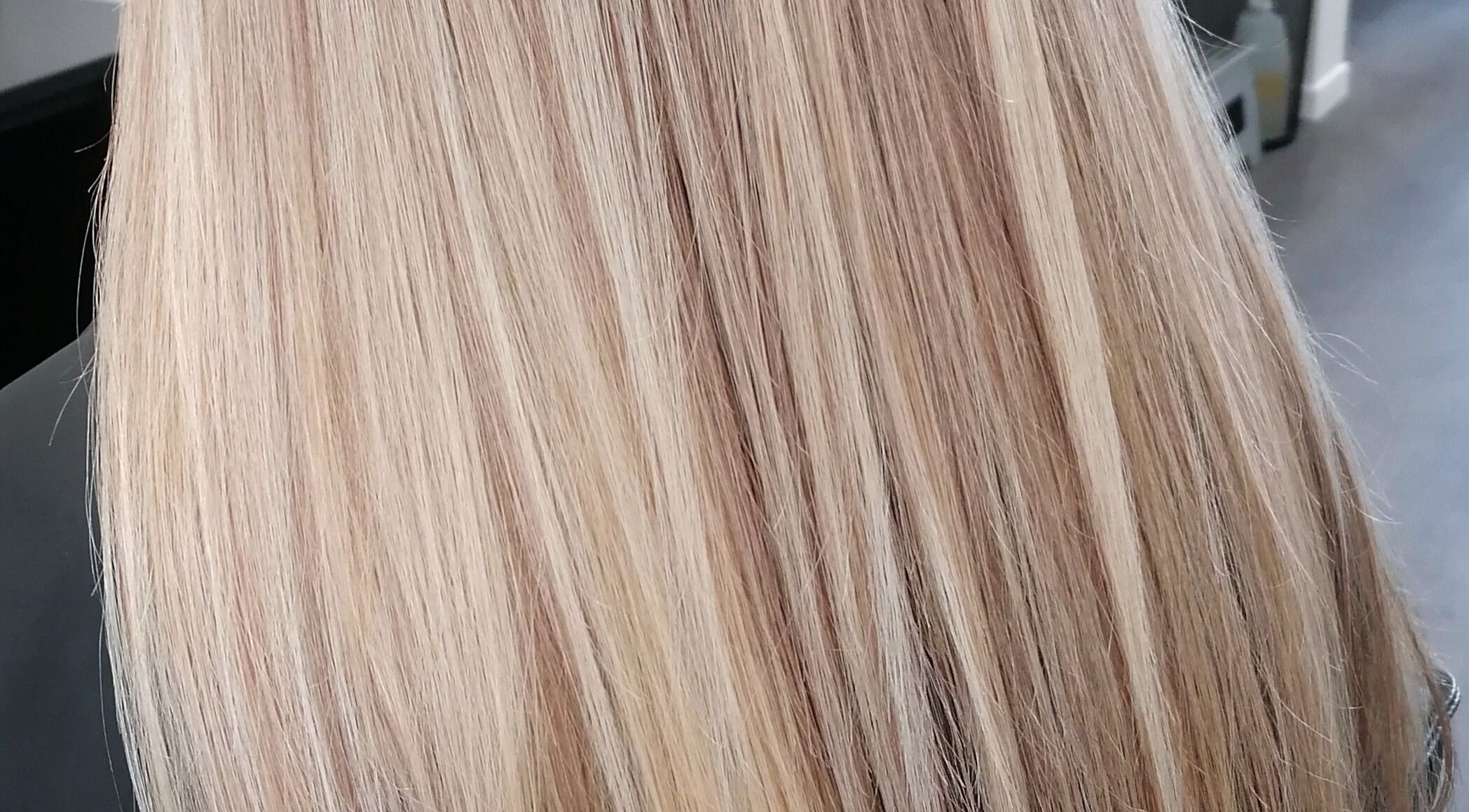 Blonde hair styled at Hair by Nicola Smit, Pretoria, Gauteng, ZA, showcasing silky shine and smooth finish.