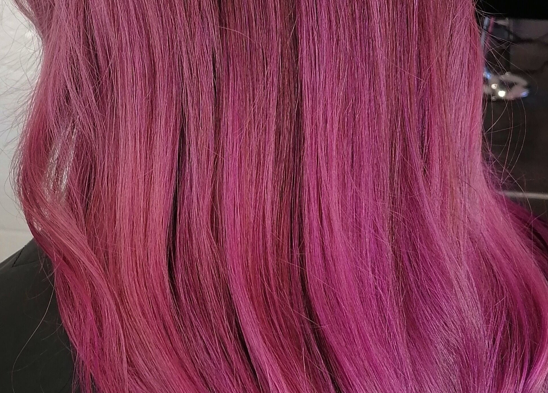 Vibrant pink hair styled by Hair by Nicola Smit, located in Pretoria, Gauteng, ZA.