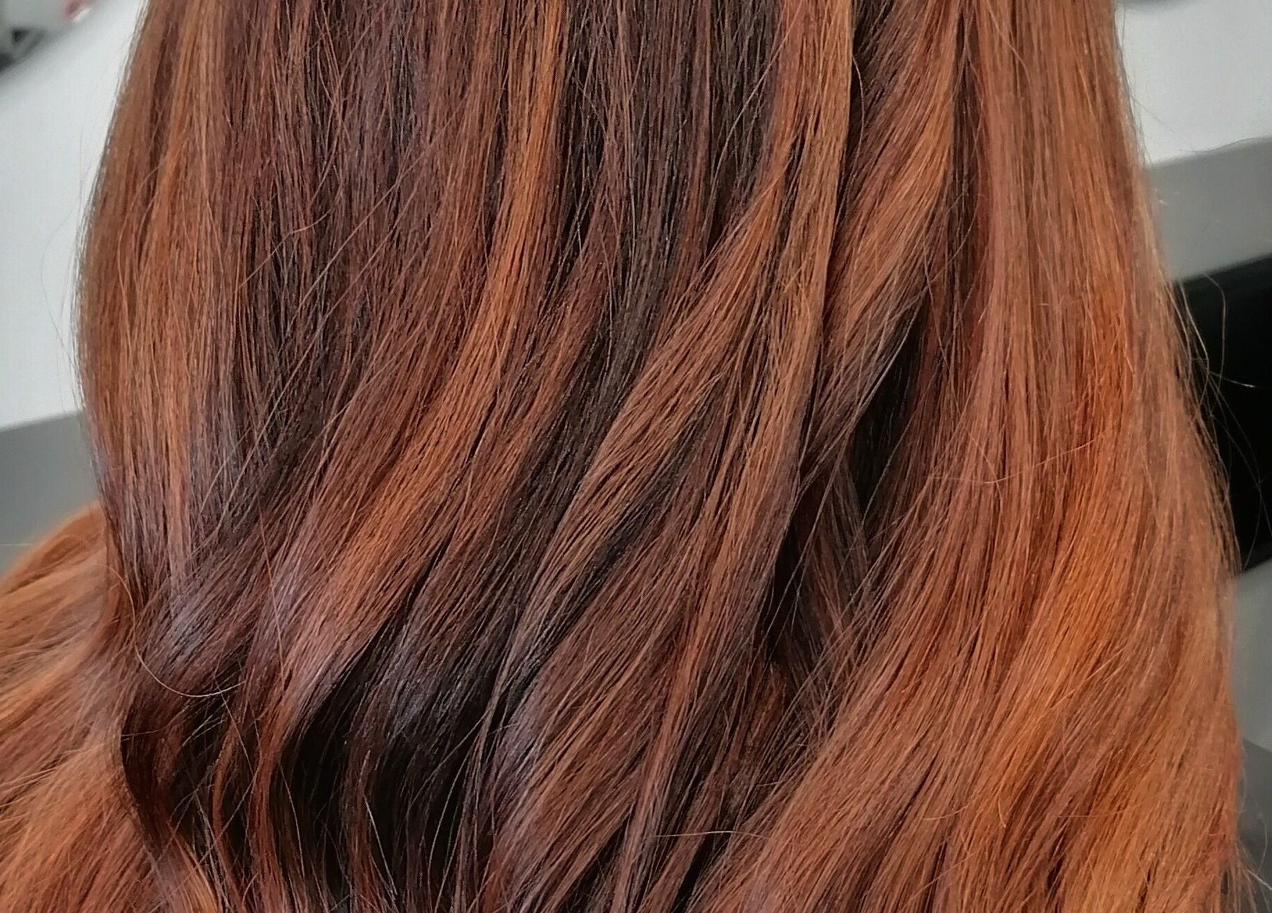 Elegant auburn hairstyle at Hair by Nicola Smit, Pretoria, Gauteng, ZA showcasing sleek, smooth finish.