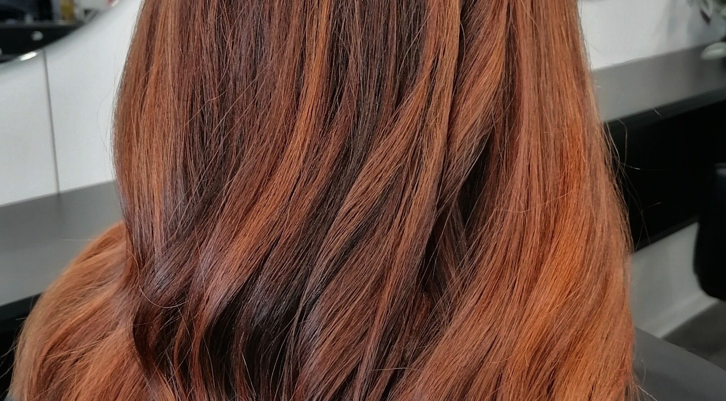 Elegant auburn hairstyle at Hair by Nicola Smit, Pretoria, Gauteng, ZA showcasing sleek, smooth finish.