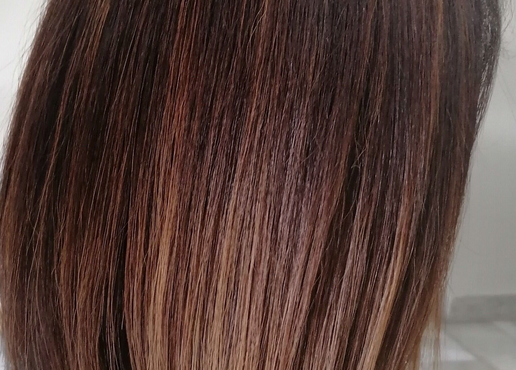 Sleek brown hairstyle at Hair by Nicola Smit, Pretoria, Gauteng, ZA. Expertly styled for a smooth finish.