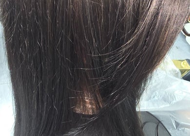 Glossy dark brown hair styling at AR Hair, Bathgate, Scotland, GB, showcasing sleek salon result.