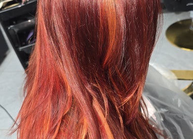 Vibrant red hair styled at AR Hair, located in Bathgate, Scotland, GB, showcasing expert coloring techniques.