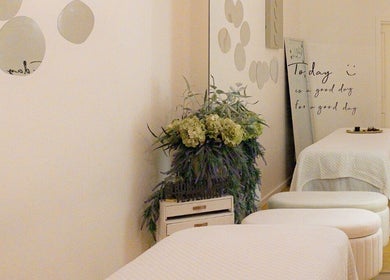 Serene treatment room at Cheewa Aroma Remedial Thai, Melbourne, Victoria, AU, with floral decor and cozy bed.