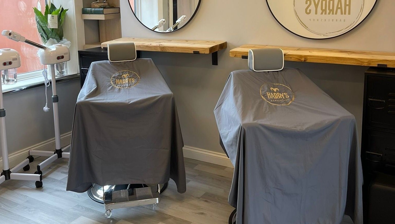 Modern barber chairs at Harry's Barbershop, Ramsbottom, England, GB offer a sleek haircut experience.