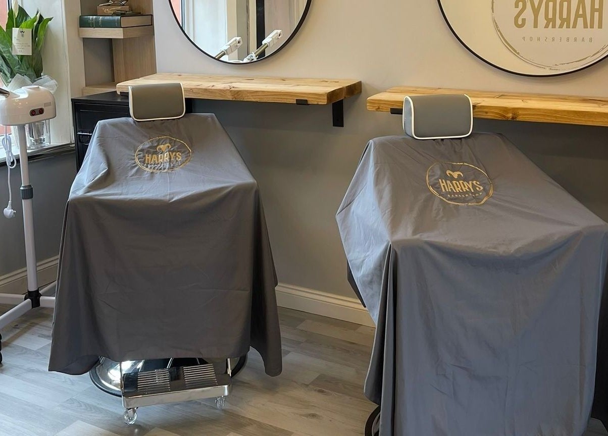 Modern barber chairs at Harry's Barbershop, Ramsbottom, England, GB offer a sleek haircut experience.